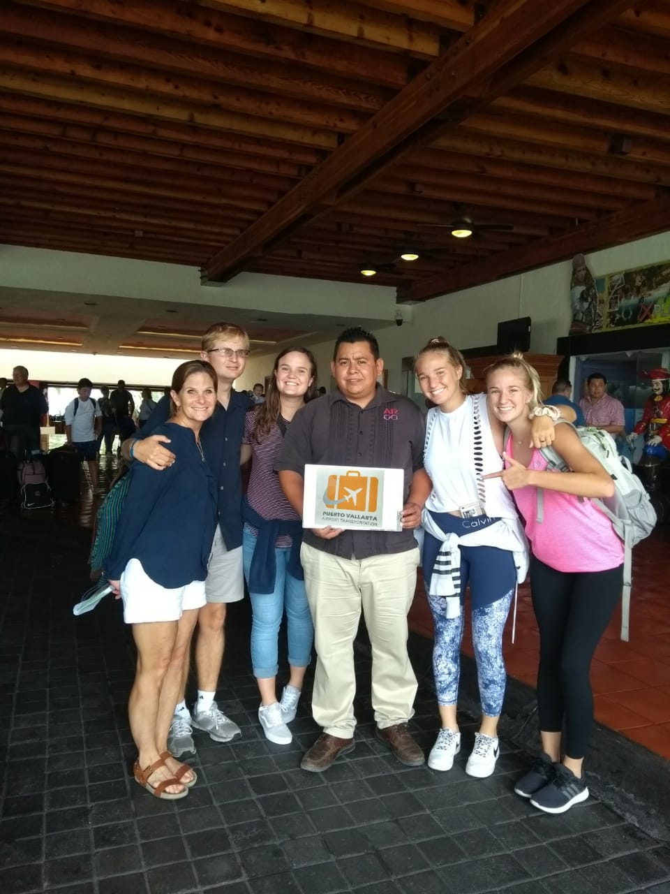 Family with a driver after arriving at their accommodation